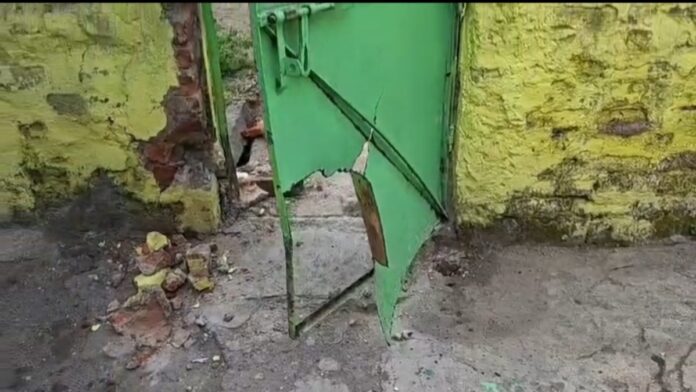 Bomb Attack on House in Dhanbad Damaged main gate of a house after a bomb attack in Dhanbad's Ramkanali area.