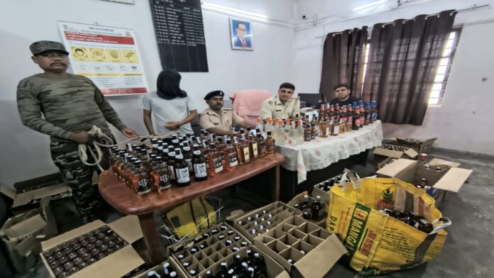 Police displaying 463 bottles of illegal liquor seized during a raid in Arki, Khunti.