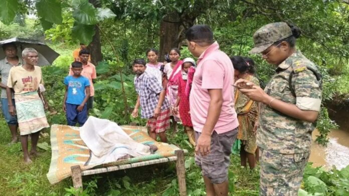 Police and local villagers recover the body of 25-year-old Kanuram Topno from a drain near Sarandiapos village in Sonua, West Singhbhum, Jharkhand.